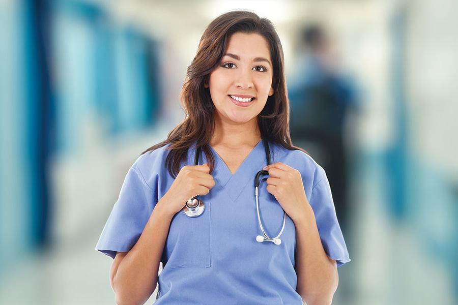 A San Juan College Medical Assistant student in blue scrubs with a stethoscope around her neck.